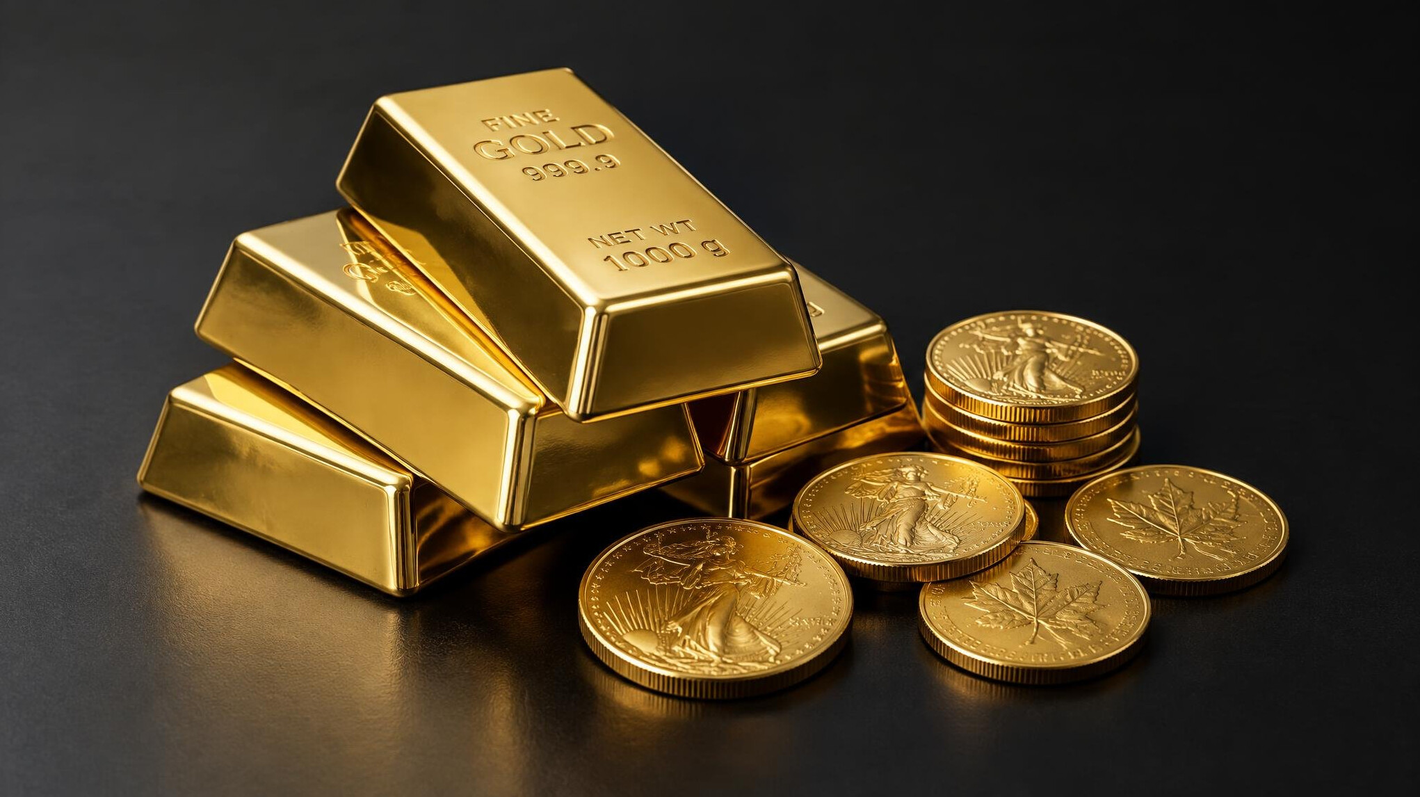 Small gold bars and gold coins on a dark surface